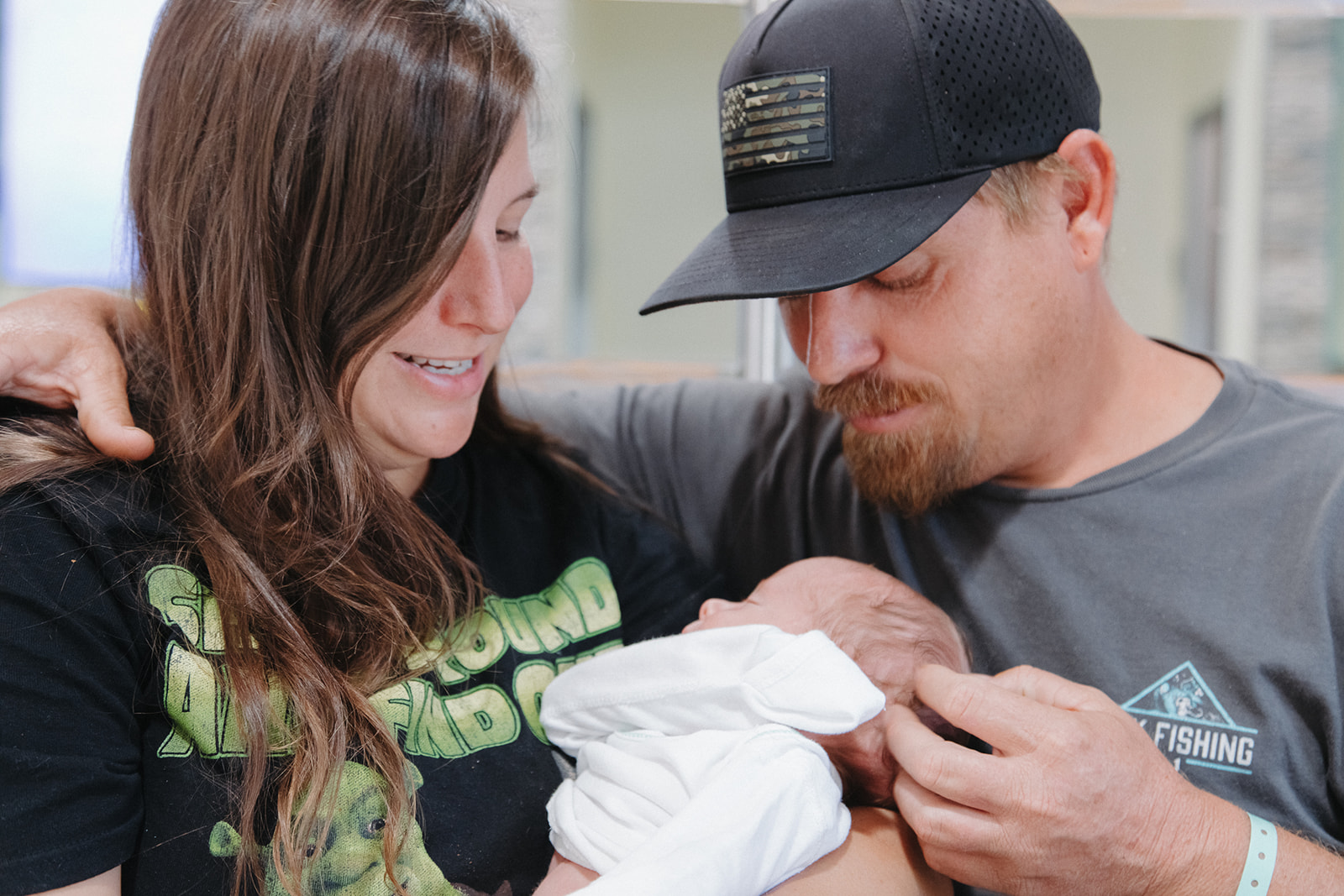 MOm and Dad looking at newborn