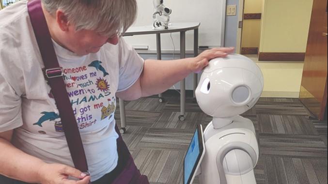 Adult interacting with robot