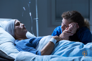 a person holding a dying person's hand to her cheek