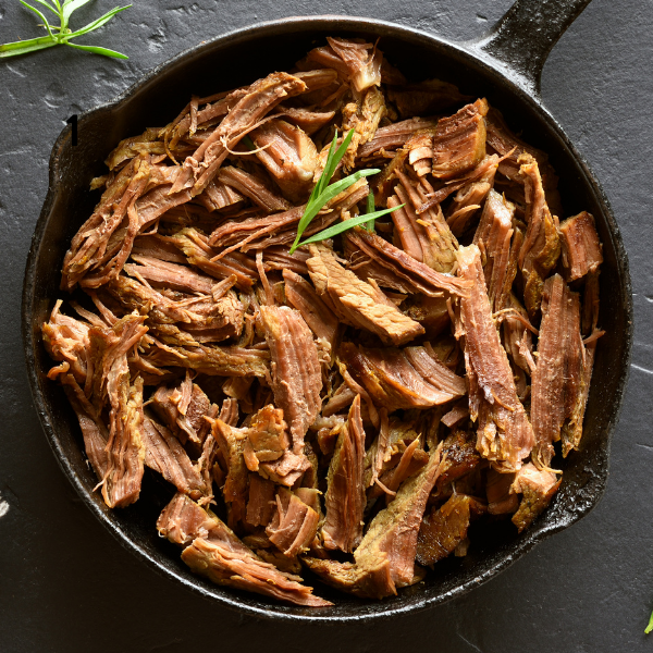 Shredded beef in a skillet.