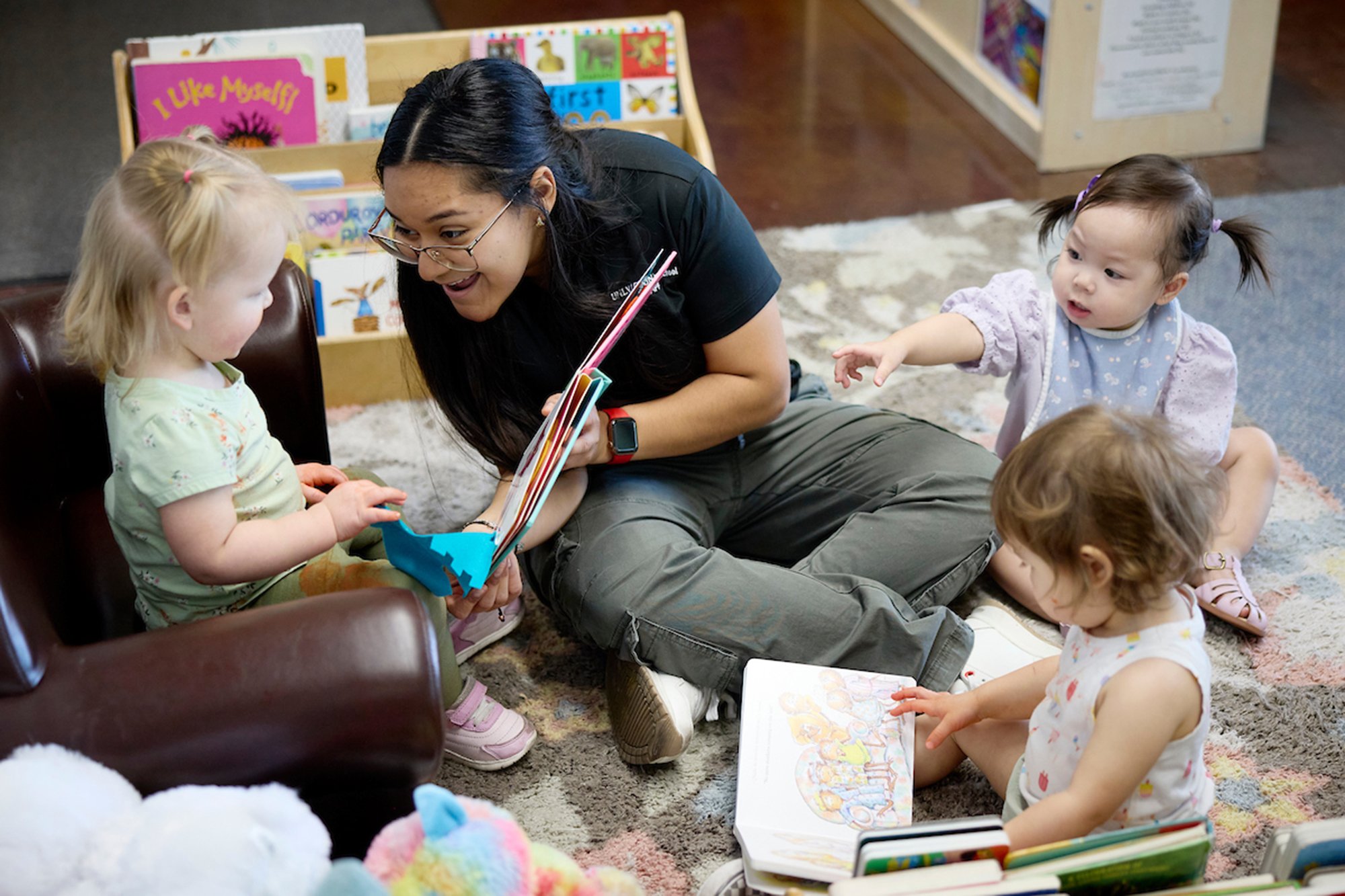 A UNLV student reading to toddlers