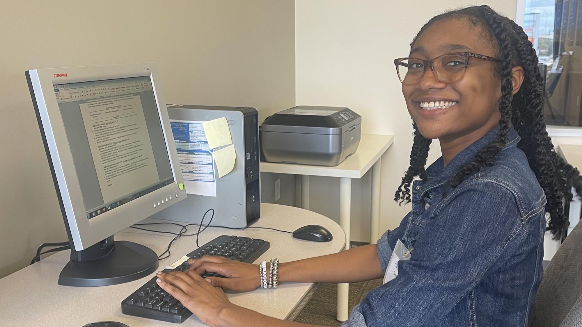 smiling student at computer