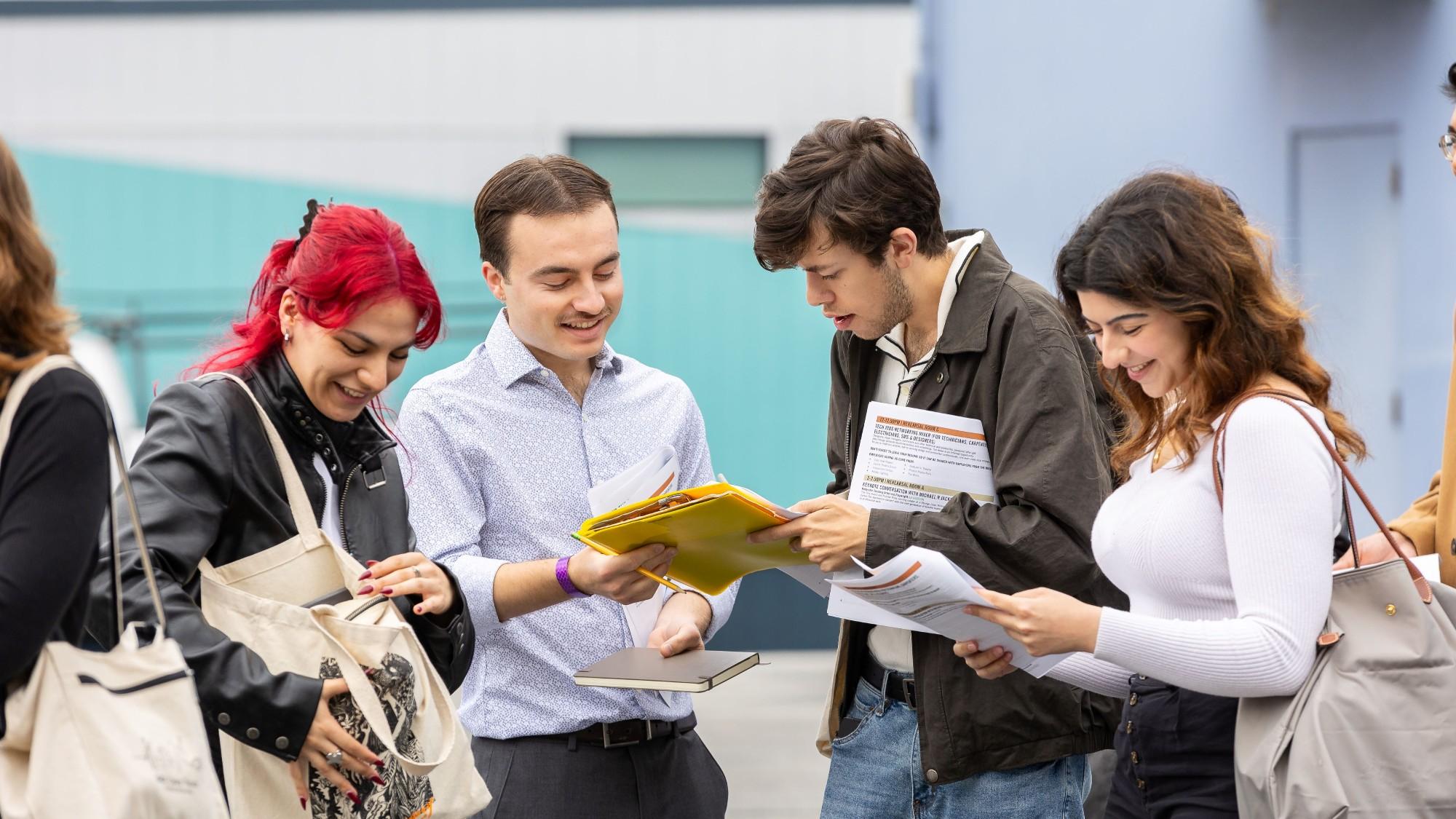 Aspiring artists talk in a group during the Going Pro Career Fair