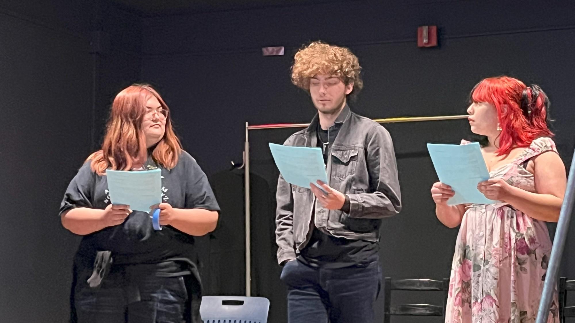 Students read from a script in their classroom.
