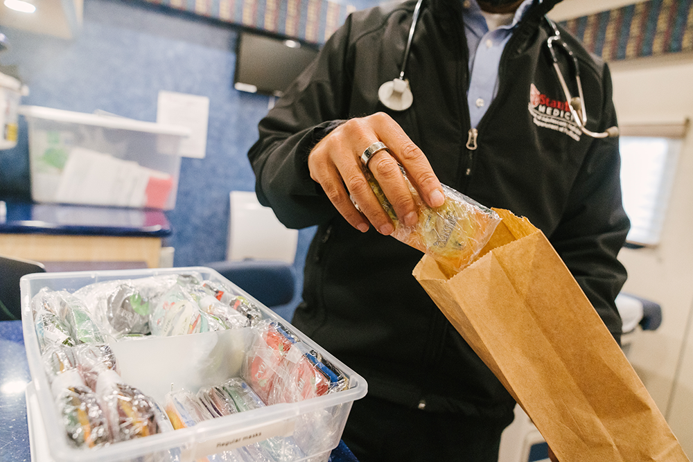 A Teen Van care team member putting supplies into a bag. 