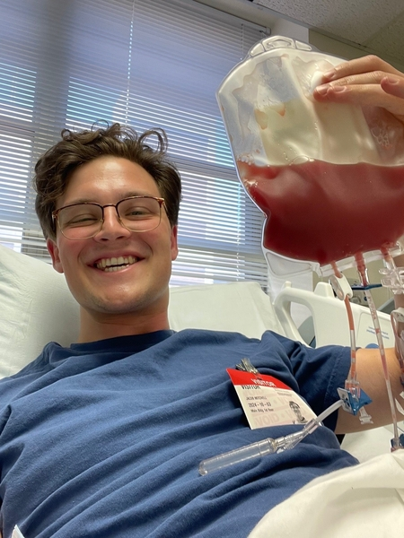 Photo of blood stem cell donor with bag of stem cells in the hospital