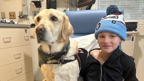 Photo of child patient with a service dog