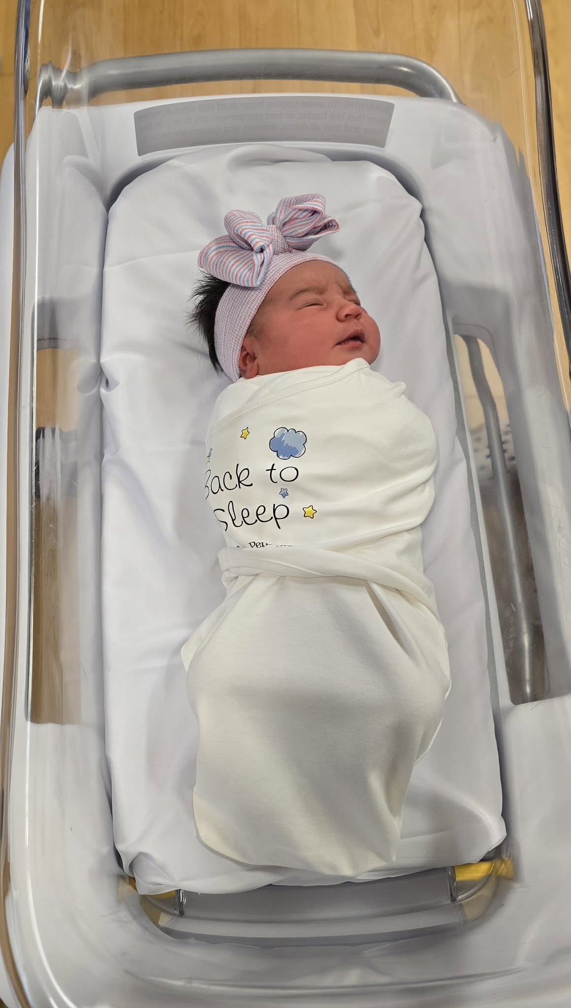 Pictured is baby Mikada wearing a sleep sack swaddle.