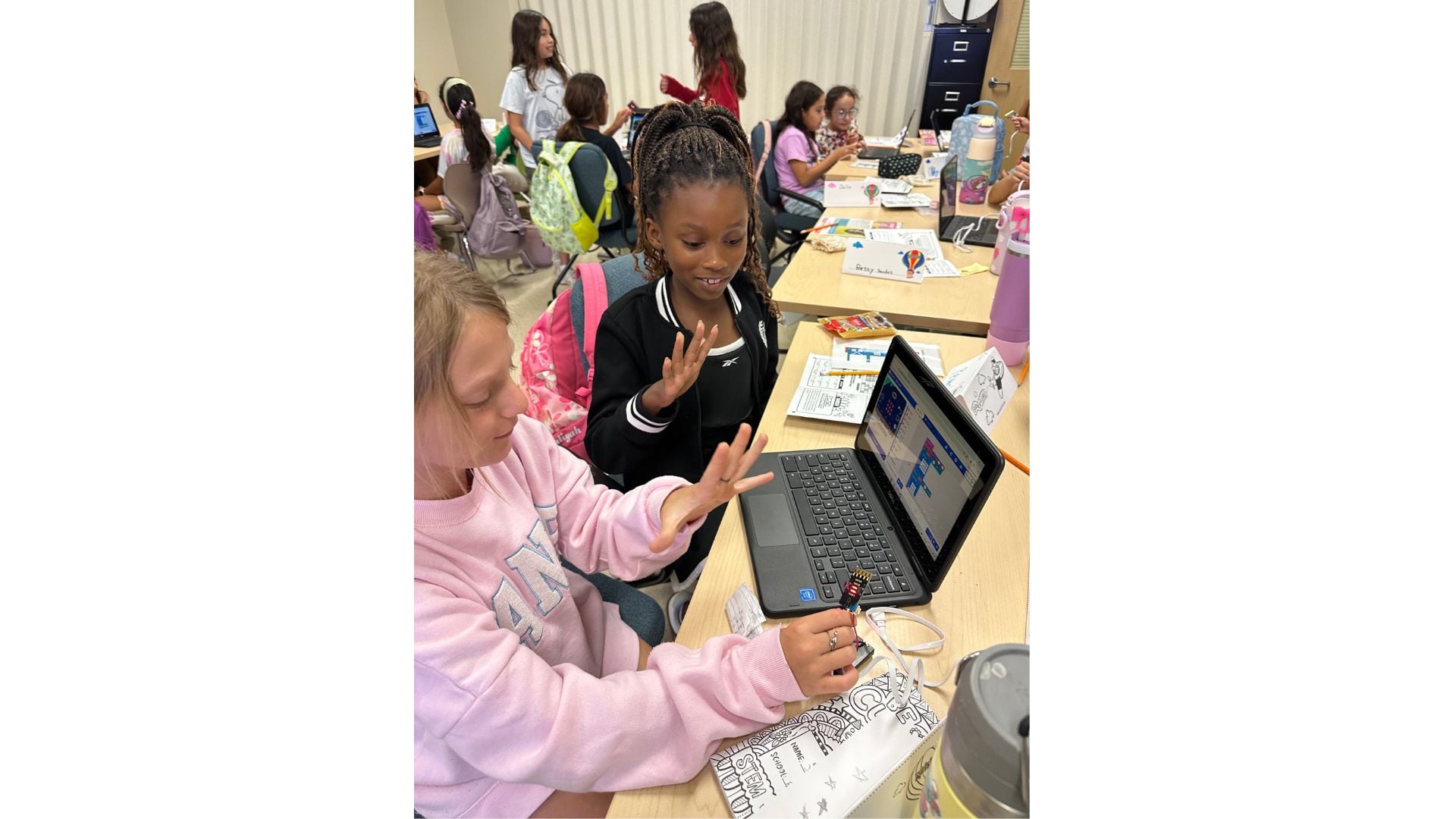 two young people at a laptop learning with STEM technology