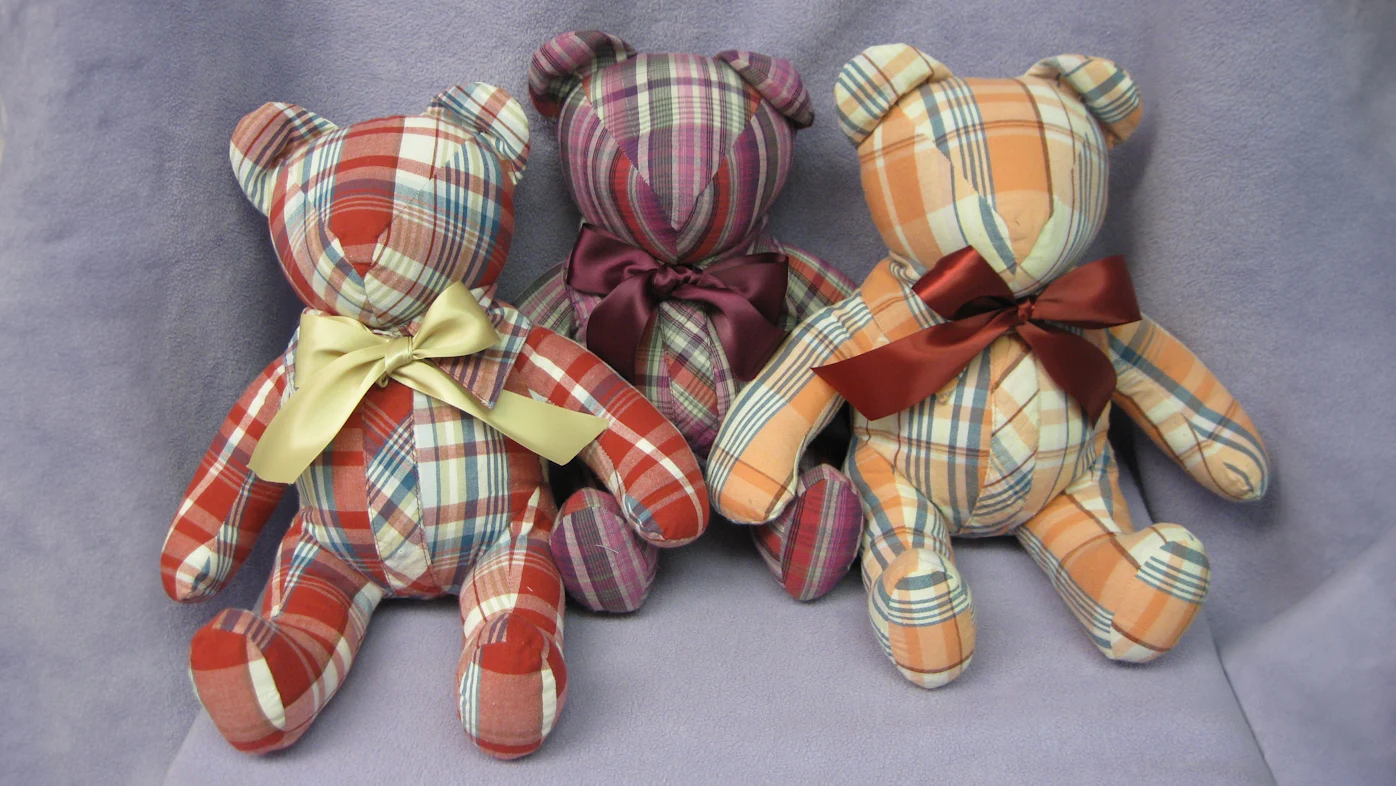 Three stuffed bears with bows.