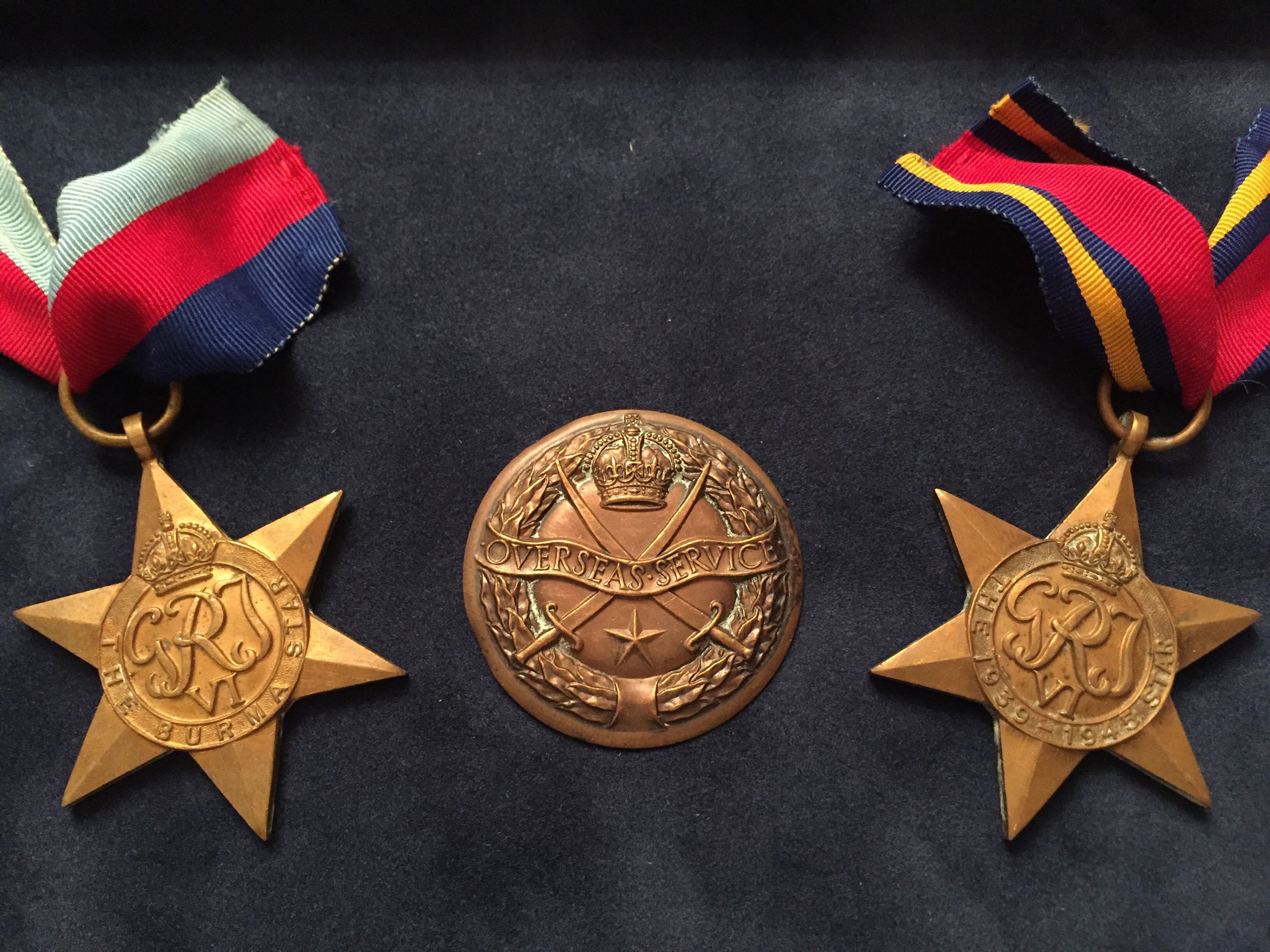 A shadowbox featuring medals of service.