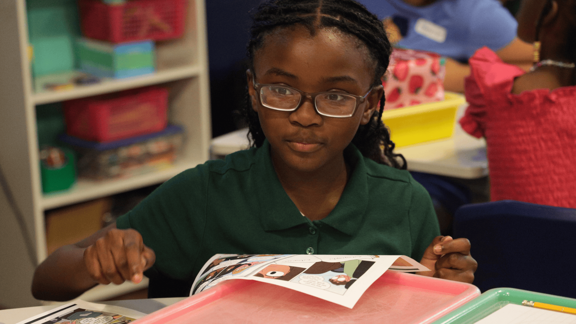 An 826NYC student is reading a graphic novel during the Write After School program.