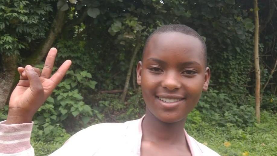 Rosemary is smiling and holding up a peace sign