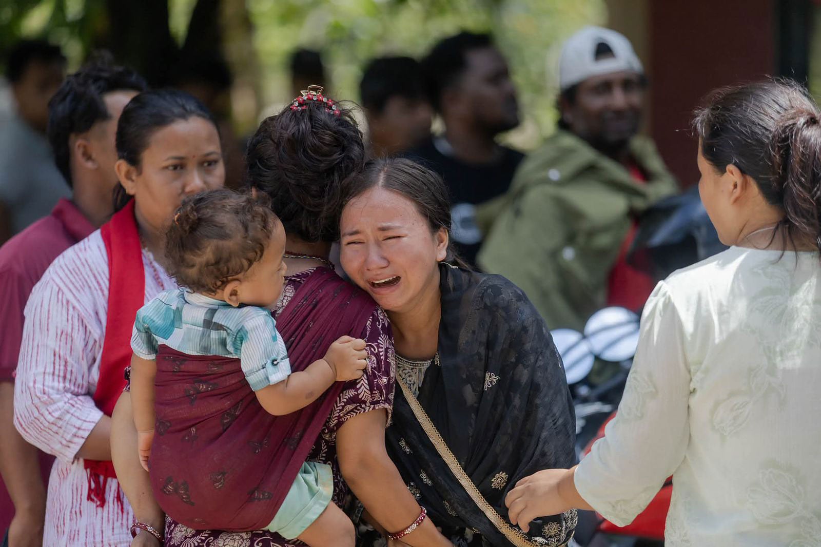 Vital Solutions - a photo from August 2026 of a family comforting one another in Nepal grieving over all the loss in the region after the disaster flooding.