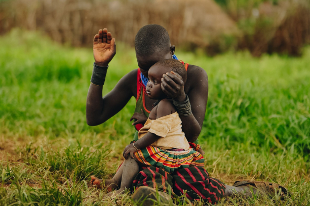 In Uganda, a mother prays with her child.