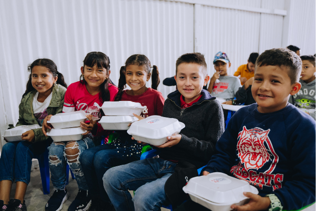 Children in Honduras receive Mercy Chefs holiday meals.