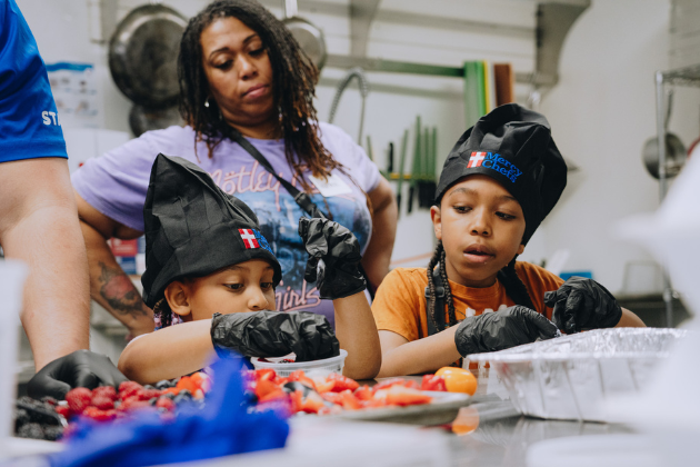 Children learn how to prepare meals at Mercy Chefs' Portsmouth Community Kitchen.