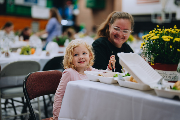 A young girl enjoys a Mercy Chefs meal with her mother in North Carolina.