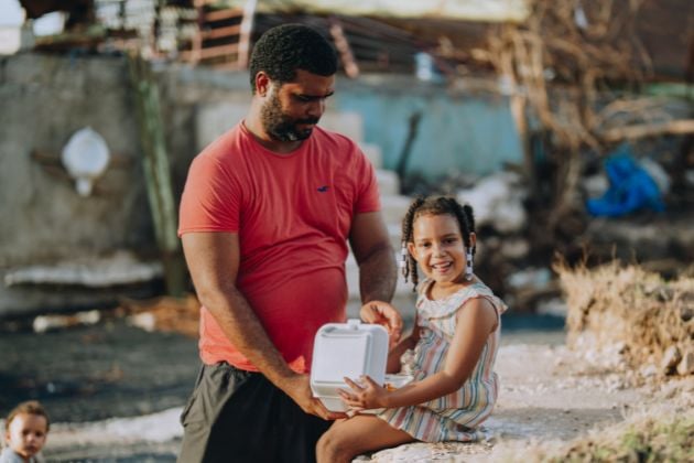 A father and daughter receive a Mercy Chefs meal in Jamaica