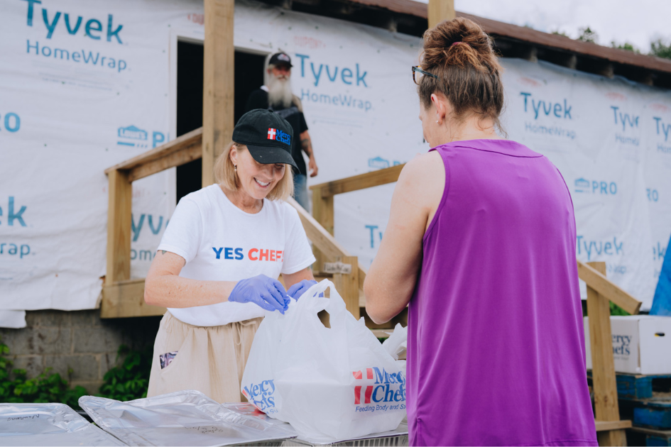 A Mercy Chefs volunteer distributes meals and groceries to hurricane victims in North Carolina.