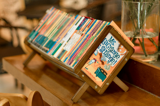 Children's books are neatly arranged in a book stand.
