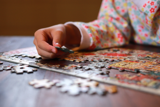 A child is putting together a puzzle.
