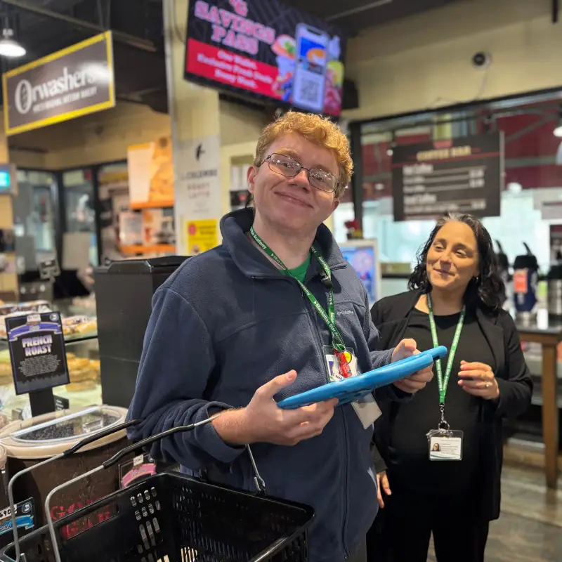 Caleb using technology in a supermarket