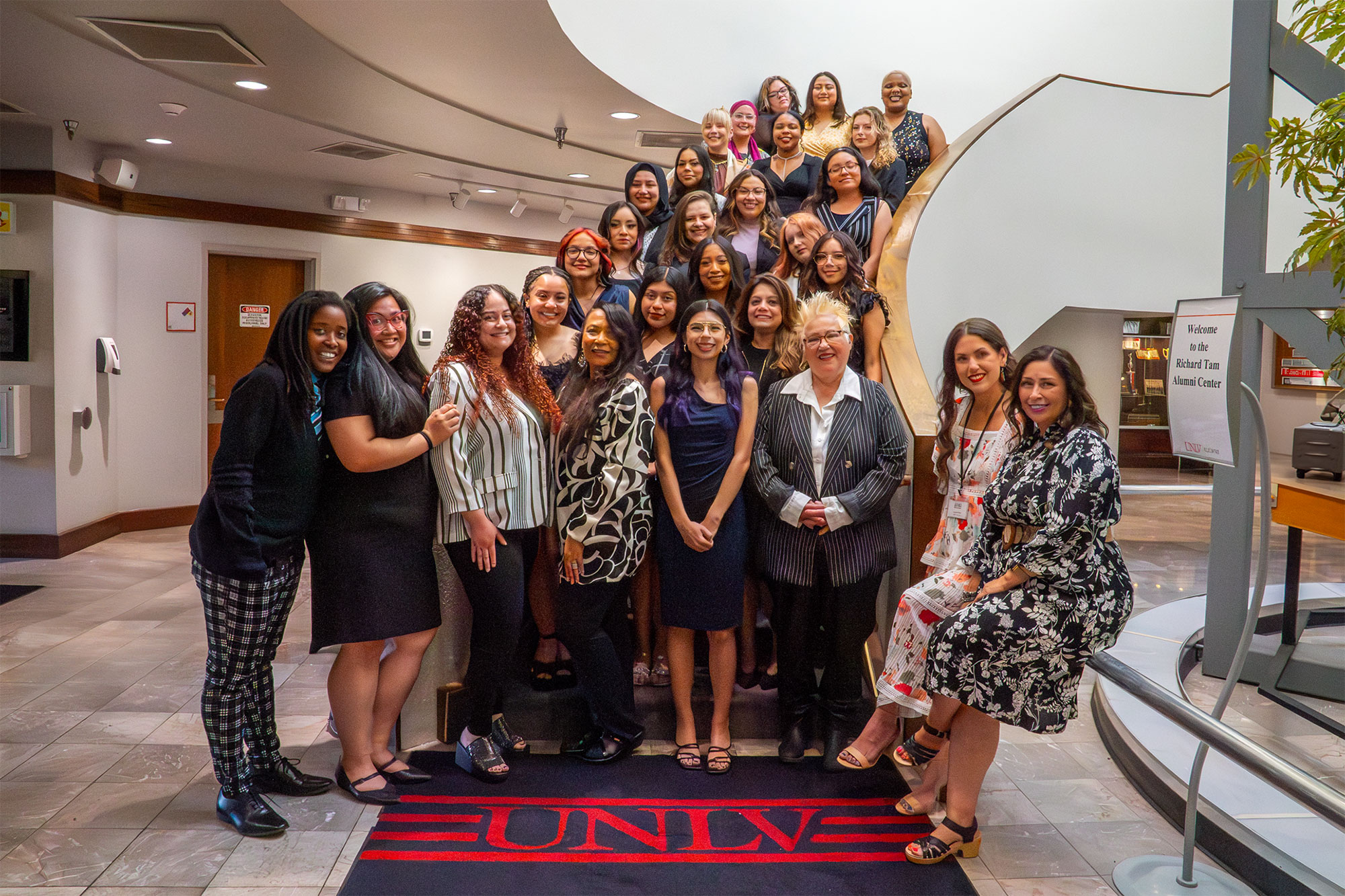 Women’s Research Institute of Nevada (WRIN) program graduates gather on a staircase.
