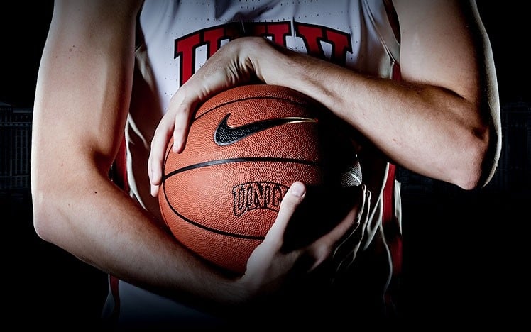 An athelete holding a basketball.