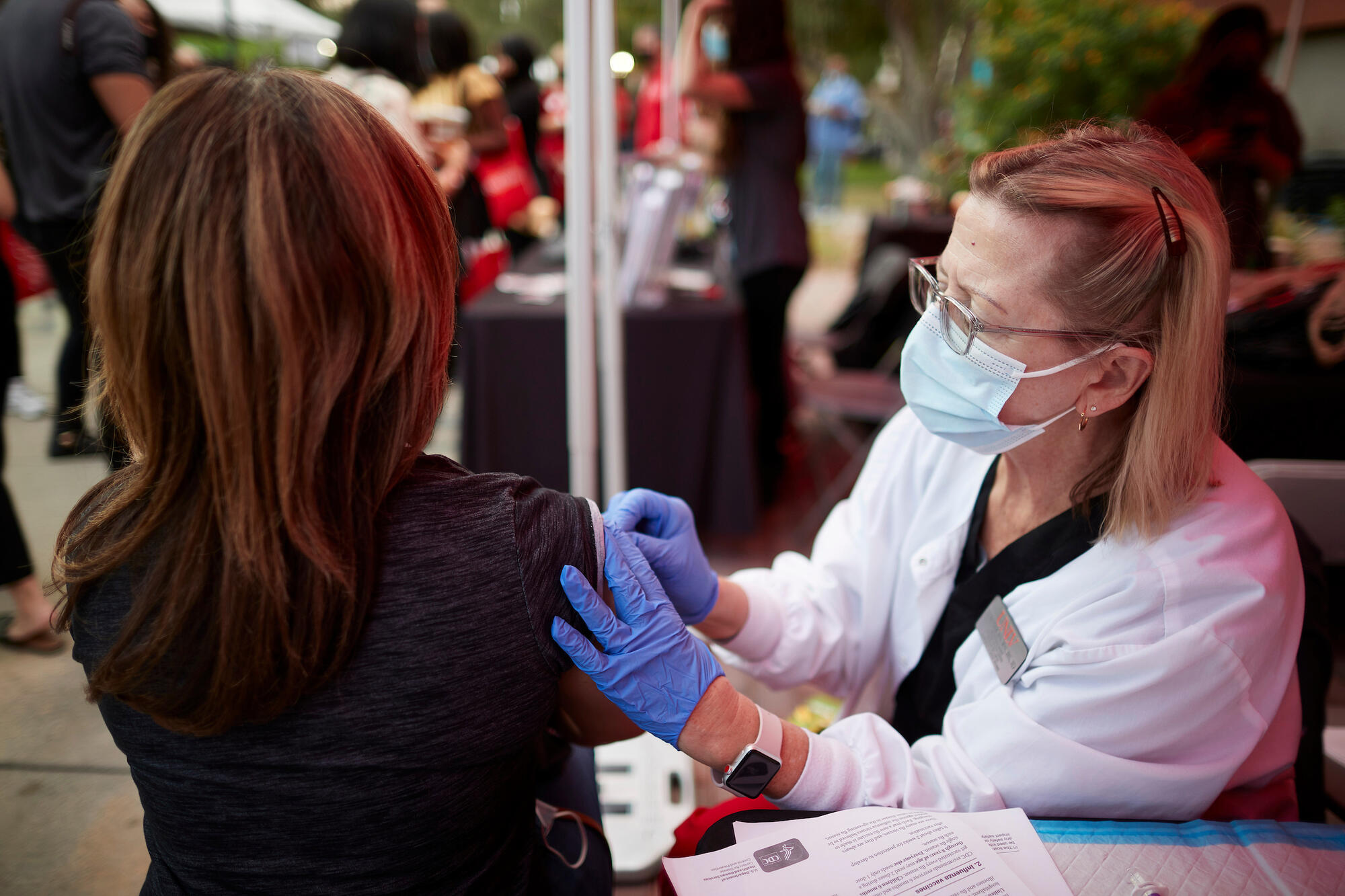 A student giving a shot at a health clinic