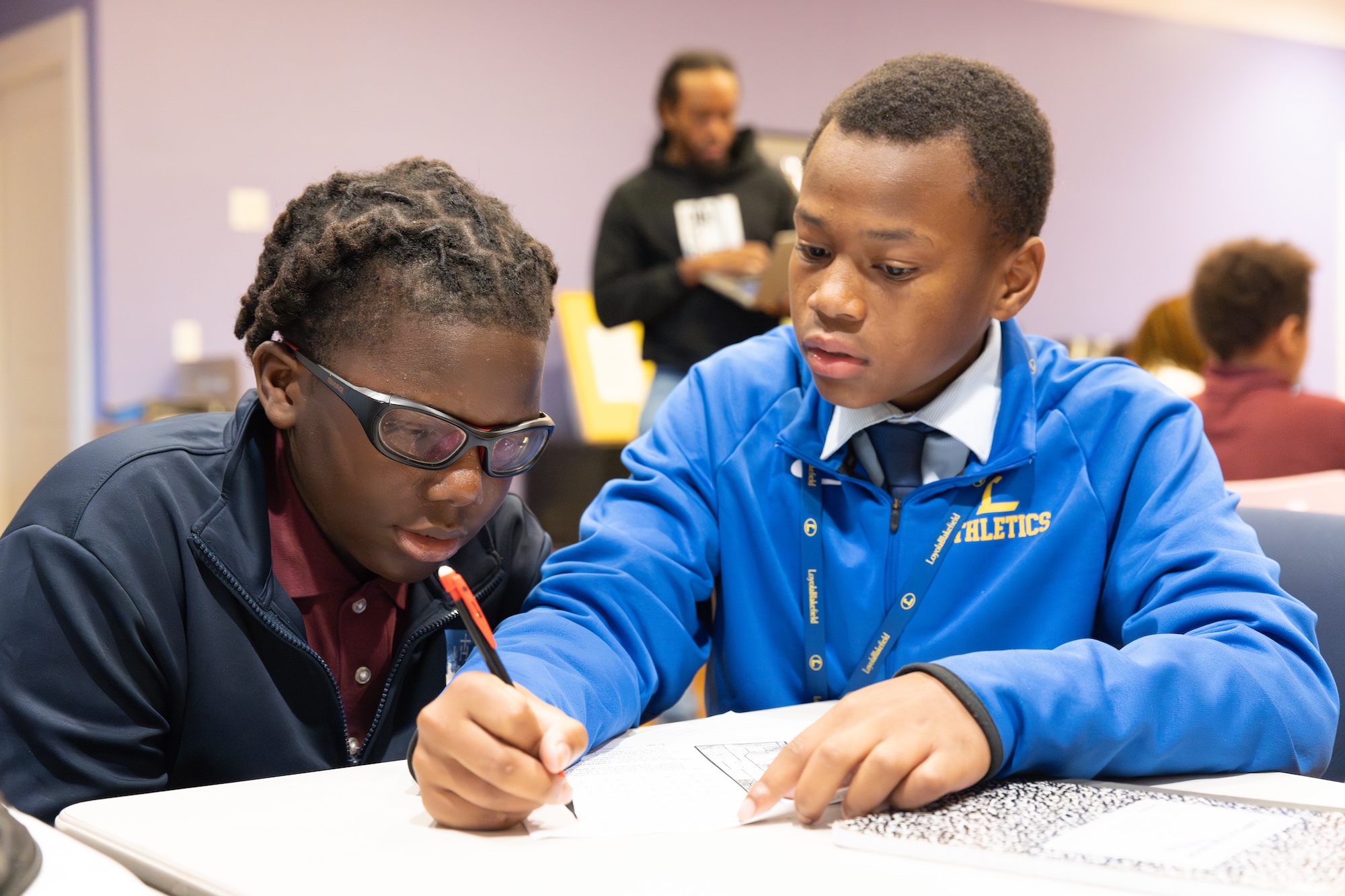 two young boys studying in study hall in the residential home after school 