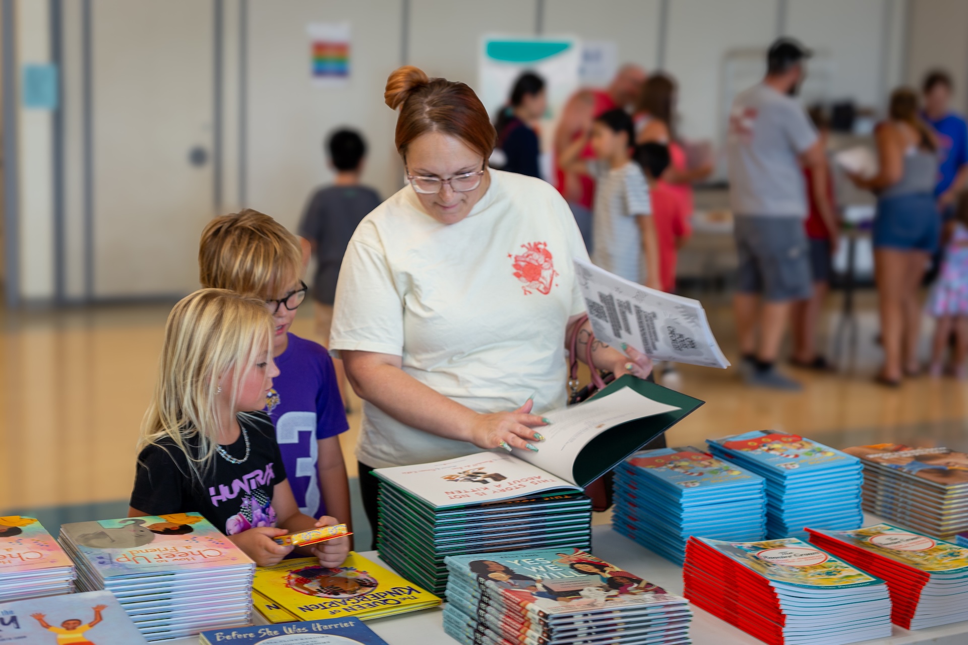 Mom and two children picking out their free books.