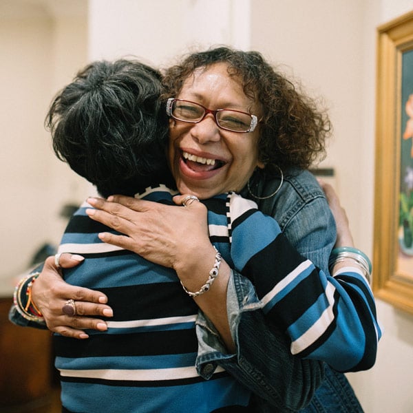 Staff and client hugging