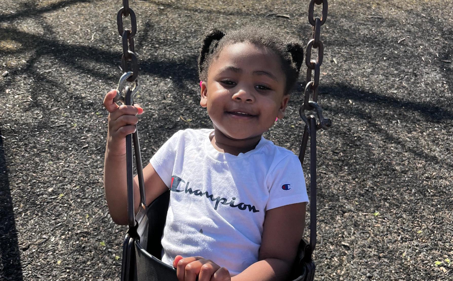 A young girl in a swing